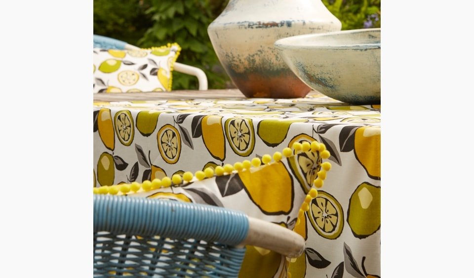Orange and lemon brightly coloured cushions and table cloth - Blinds Norfolk - Norwich Sunblinds