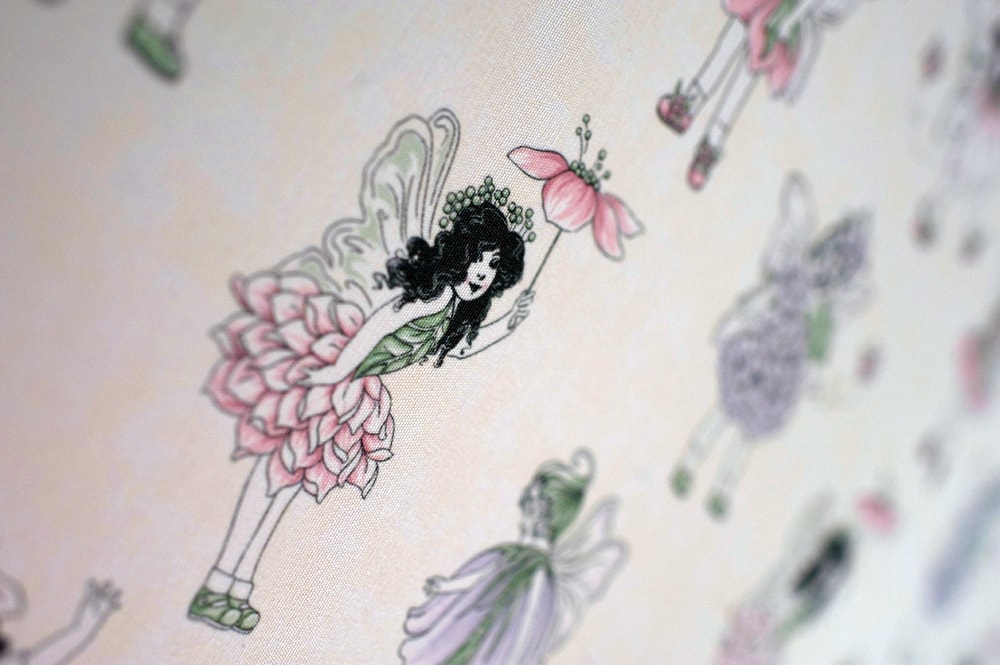 Purple Flower fairies with cream background in close up image of roller blind - Blinds Norfolk - Norwich Sunblinds