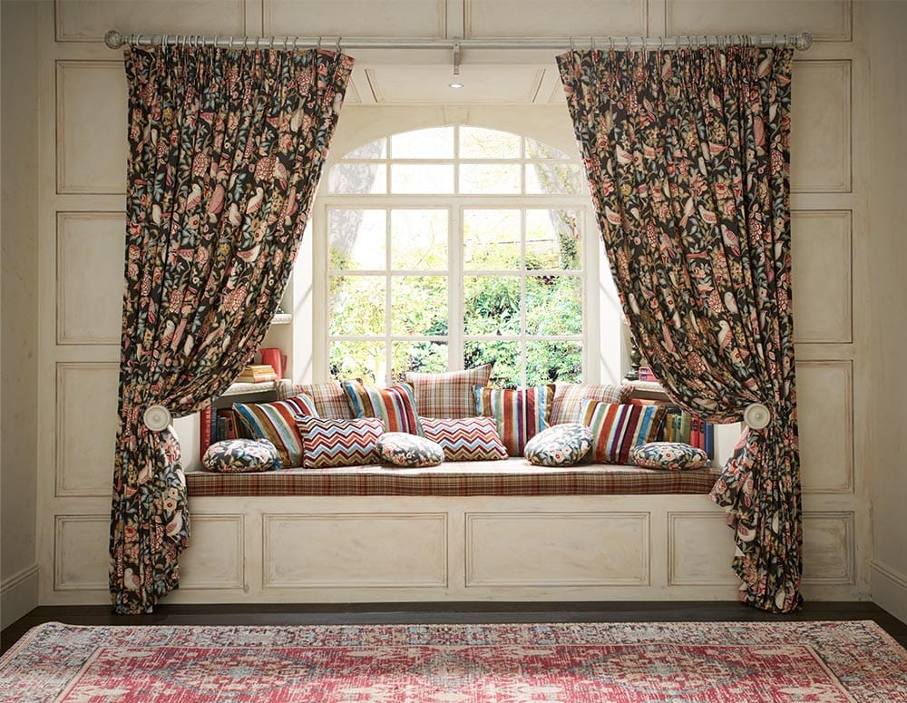 Auburn curtains with tie-backs in a bay window with window seat and cushions. - Curtains Norfolk - Norwich Sunblinds