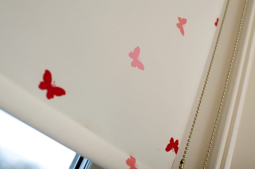 Roller blinds with pink and red butterflies on cream background - Blinds Norfolk - Norwich Sunblinds