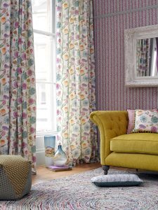 Curtains for the lounge in Myanmar fabric with multi-coloured designs on cream background - Blinds Norfolk - Norwich Sunblinds