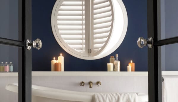 Circular shutters for a porthole style window in a wonderful bathroom