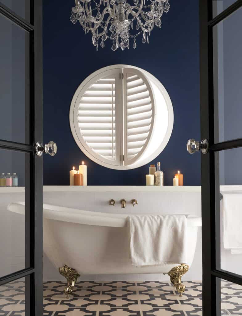 Circular shutters for a porthole style window in a wonderful bathroom