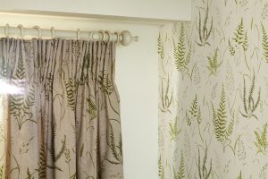Soft red botanica design fabric with green fern detail. - Curtains Norfolk - Norwich Sunblinds