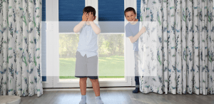 Two boys playing hide and seek in curtains | Norwich Sunblinds