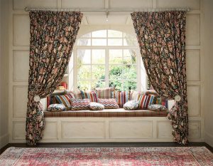 Auburn curtains with tie-backs in a bay window with window seat and cushions. Curtains Norfolk - Norwich Sunblinds