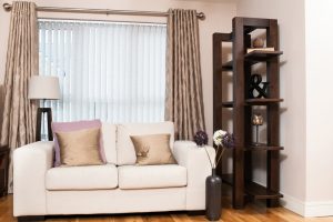 Vertical blind with complementary curtains in lounge - Blinds Norfolk - Norwich Sunblinds
