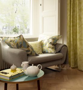 Sofa with cushions made in fabric to co-ordinate with cream curtains