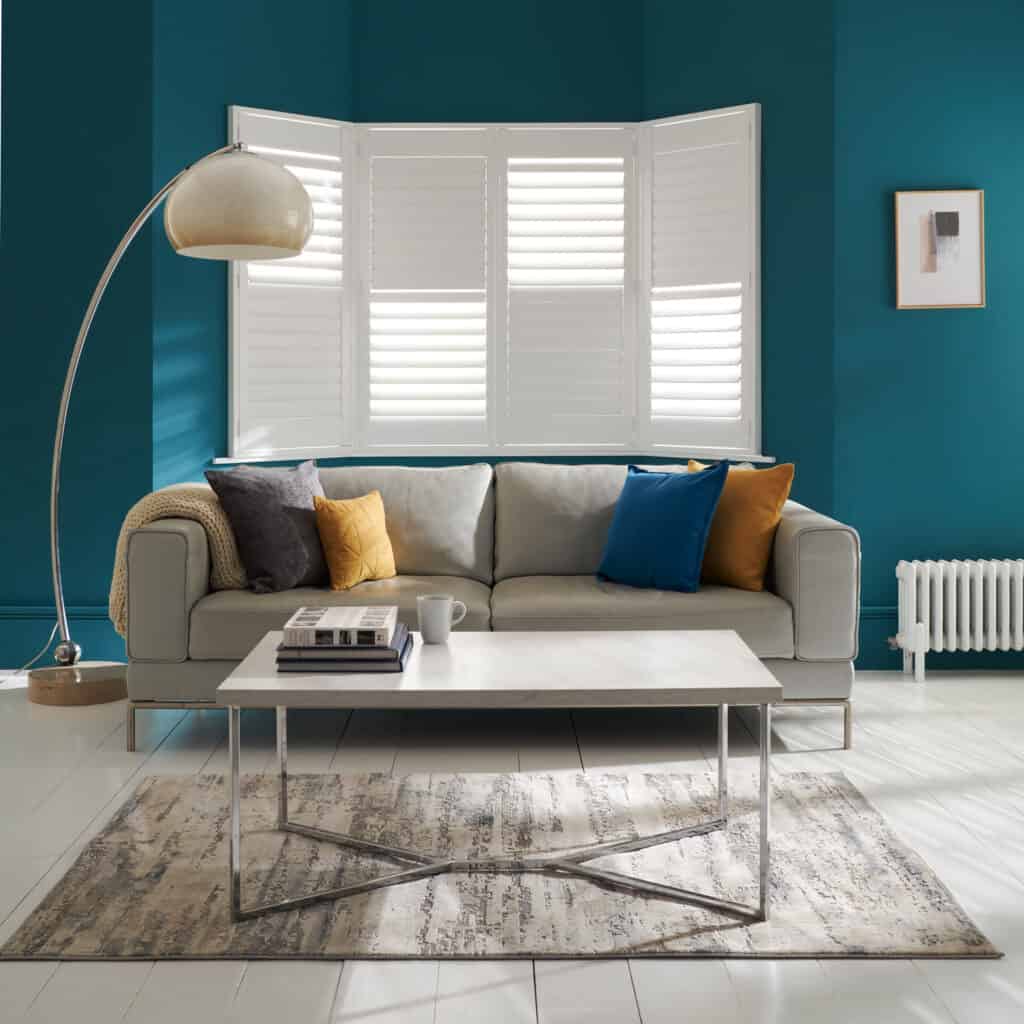 Antigua design plantation shutters in a living room setting